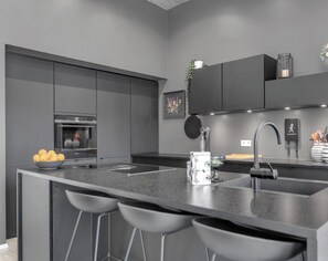 Enjoy cooking in this well-lit kitchen with an oven and spacious island.
