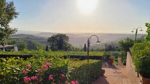 A brick pathway leading to a scenic overlook with a view of distant hills and a clear sky. - VILLA BELLAVISTA-TUSCANY-POOL -JACUZZI- breath-taking view-great for family (Toscana)