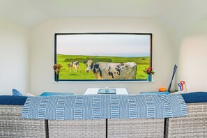 A room with a large window displaying a landscape painting of cows. - 5-star rural escape hidden between the coastal towns of Kinsale and Clonakilty, (Clonakilty)
