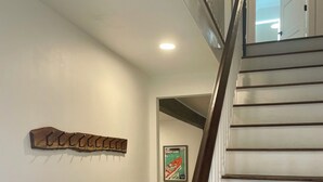 A staircase with wooden steps and a dark balustrade. - Downtown Wolfeboro! Walk to the lake, restaurants and park (Wolfeboro)