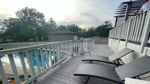 A wooden deck with a pool, outdoor seating, and a covered area. - POOL house with FENCED Yard for Pets, by the ARK Encounter, Airport, Cincinnati (Independence)