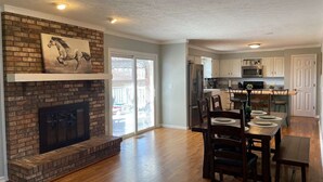 A spacious kitchen with white cabinets, a stainless steel refrigerator, and a microwave. - POOL house with FENCED Yard for Pets, by the ARK Encounter, Airport, Cincinnati (Independence)