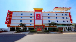 A multi-story hotel with a prominent red and yellow facade, a central entrance, and a sign indicating a 5-star rating. - Hotel Sogo Macapagal  (Parañaque)