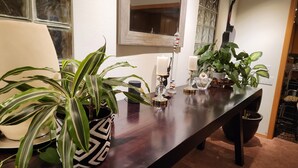 A dining table with decorative items, potted plants, and candles. - Cheerful Single Story 3-bedroom home w pool table (Santa Clarita)