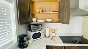 A compact kitchen with a built-in microwave, a coffee maker, and a stove. - Beautiful place and view to rest and clear your mind.#1 (Antioch)