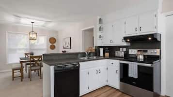 Enjoy cooking in this well-equipped kitchen with a central island, ample counter space, and modern appliances.