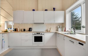 Enjoy cooking in this well-equipped kitchen with a stainless steel oven, sink, and coffee maker.