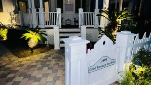 A two-story house with a porch, a mailbox, and a brick driveway. - Newly Remodeled. 20 second walk to Beach walkover. Gulf views on 2nd/3rd floors! (Panama City Beach)
