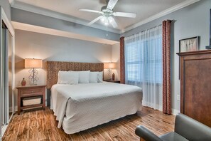A bedroom with a large bed, two bedside tables with lamps, a ceiling fan, and a window with curtains. - *Gulf-Front at Palazzo! *Fall Specials! (Panama City Beach)