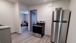A modern kitchen with a stainless steel refrigerator, a built-in oven, and a microwave. - Jackalope Loft in Downtown Custer, Sleeps 6 (Custer)