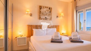 A hotel room with a bed, two bedside tables, a wall-mounted radiator, and a window with curtains. - CostaBlancaDreams - Capri in Calpe (Calpe)
