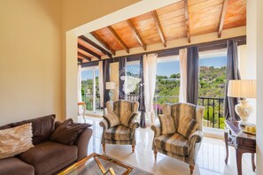 A spacious living room with a high ceiling, large windows, and a view of a lush landscape. - CostaBlancaDreams - Casa Altea in Altea (Altea)