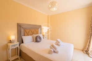 A hotel room with a bed, a nightstand, a lamp, and a decorative ceiling light. - CostaBlancaDreams - Casa Altea in Altea (Altea)