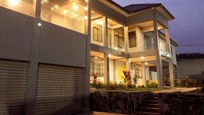 A multi-story building with a covered entrance and a garage.