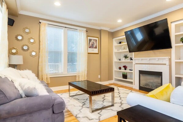 Smart TV, fireplace, books, computer monitors