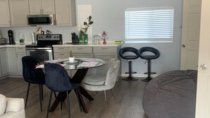 A modern kitchen with a dining area, a large bean bag, and a window with blinds. - Plan ahead your next vacation with the at home feeling.  (Yakima)