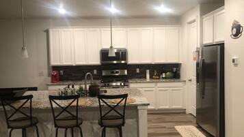 Coffee/tea maker, fridge, microwave, oven