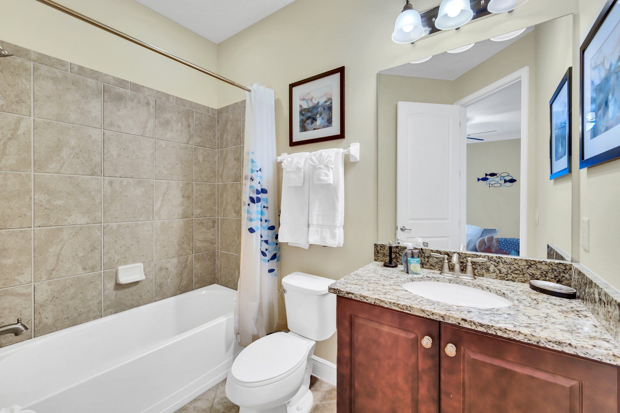 A bathroom with a bathtub, toilet, and sink.