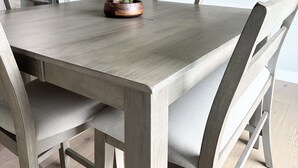 A dining area with a rectangular table, six chairs, and a potted plant. - Comfort by Southridge (Kennewick)