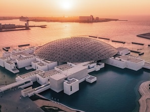 A large, modern building with a distinctive dome structure surrounded by water. - InterContinental Residences Abu Dhabi by IHG (Abu Dhabi)