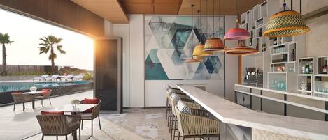 A modern bar area with a pool view, geometric wall art, and wicker furniture.