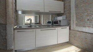 A compact kitchen with white cabinets, a built-in microwave, and a sink. - Villa Veli Varos, 4 bedrooms, near Diocletian pallace, Split old town (Split)