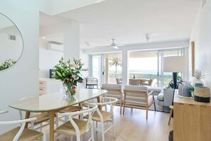 Un intérieur moderne comprenant un coin repas, un canapé et une vue sur l’extérieur.
