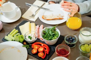 A breakfast setting with various food items and drinks on a table. - Apart-Hotel Laurus (Lech am Arlberg)