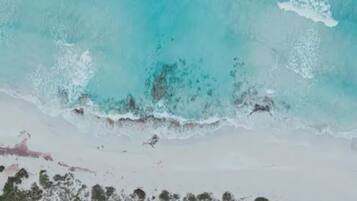 On the beach, white sand, sun loungers, beach umbrellas