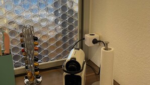 A wooden table with a camera, a roll of toilet paper, and a wine rack. - Apartment Thermen-zeit (Bad Fuessing)