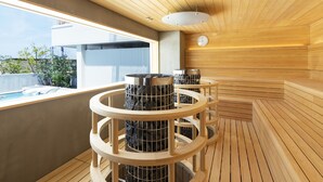 A modern sauna with wooden benches and a stone pillar. - KAMOME SLOW HOTEL THE COMPACT (Awaji)