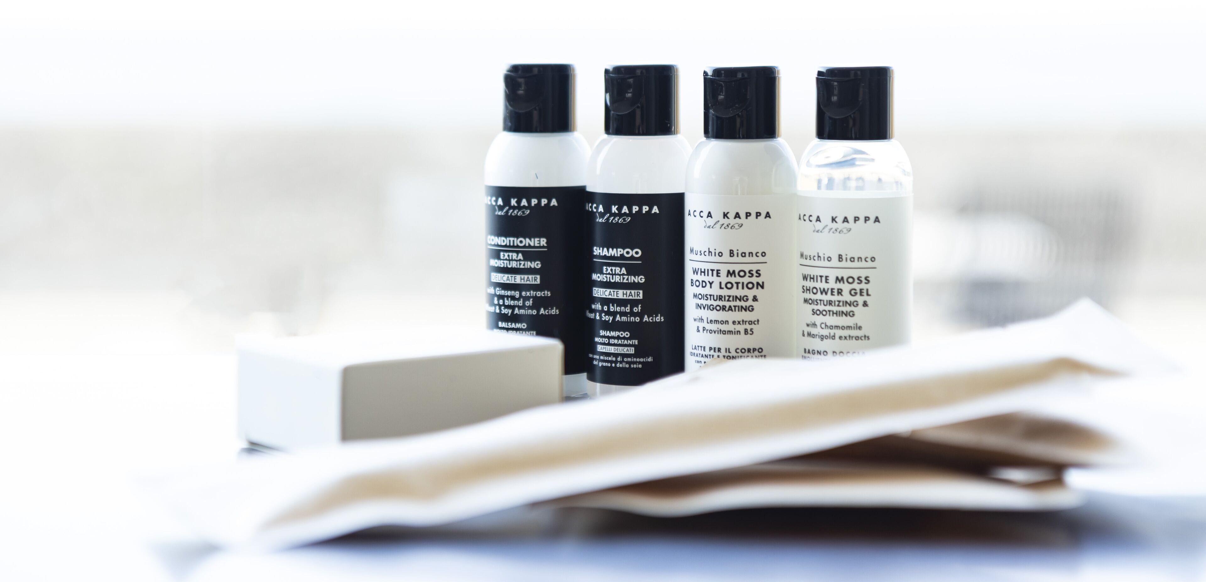 Four bottles of Aacca Kappa hair care products on a white surface.