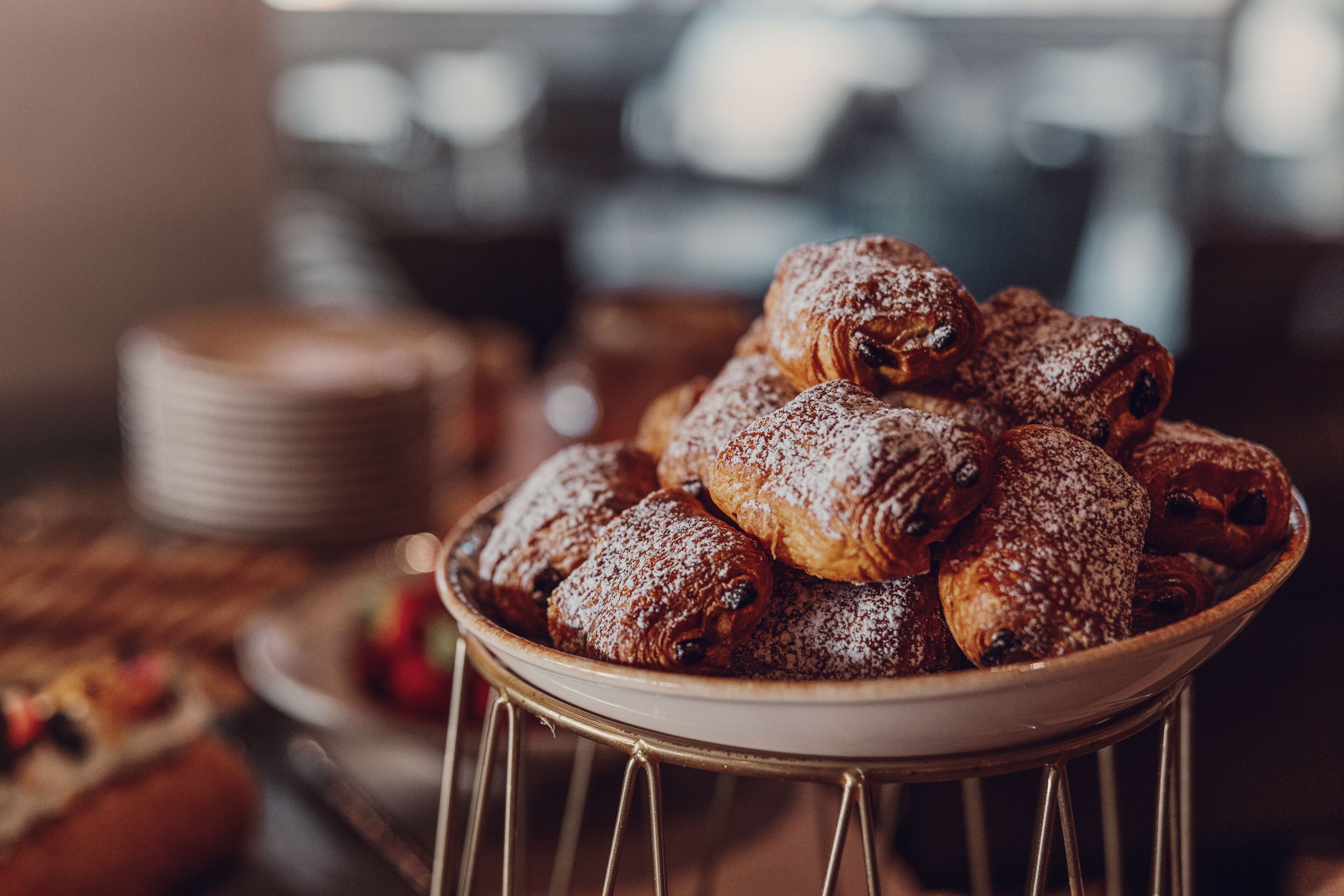 A bowl of pastries dusted with powdered sugar.