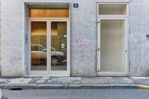 A building with a glass door entrance, a garage door, and a number '4' sign.