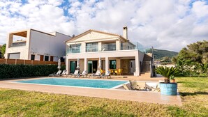 A modern house with a swimming pool, outdoor seating, and a mountain view. - MaDiZé Beach House on the Sea (Zakynthos)