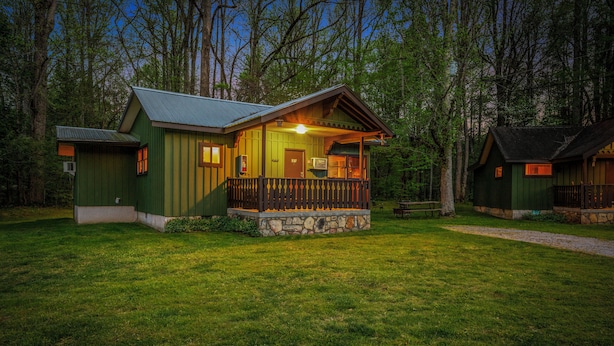 A cabin with a porch, a stone foundation, and a door labeled '3B'.