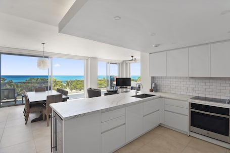 O Condo 22 | Private kitchen | Full-size fridge, microwave, oven, stovetop. O Condominium Beachfront Residences