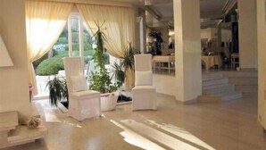 A spacious lobby with a high ceiling, large windows with curtains, and a staircase leading to another area. - Large 600M2 property, tennis and 60sqm pool house with bar-kitchen on 10000 sqm (Mougins)
