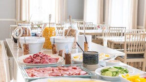 Una mesa de buffet con diversos alimentos y utensilios.