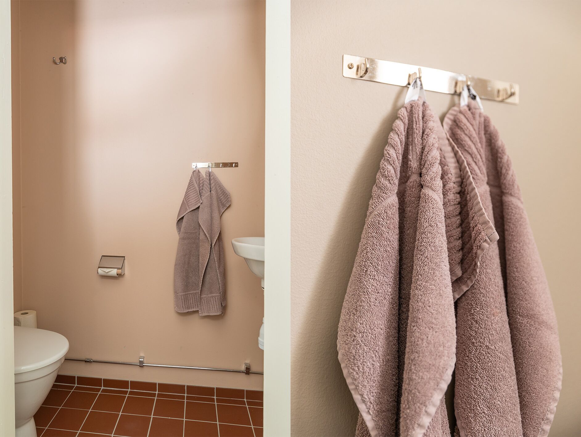 A bathroom with a toilet, a sink, and a towel rack with two towels.