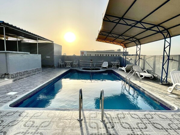 2 outdoor pools, open 8:00 AM to 7:00 PM, pool umbrellas, pool loungers