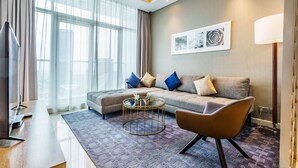 Luxury Apartment | Living area | 56-inch Smart TV with cable channels, TV, Netflix - Stunning 2BR with Balcony-Canal View (Dubai)