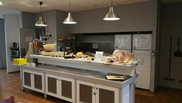 A buffet setup with various food items and a refrigerator in the background. - Auberge de Jeunesse HI Boulogne-sur-Mer (Boulogne-sur-Mer)