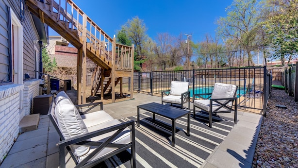 A patio with outdoor furniture, a pool, and a wooden deck. - Private Apartment with pool, 5 min to downtown (Tulsa)