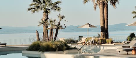 Seasonal outdoor pool, pool umbrellas, pool loungers