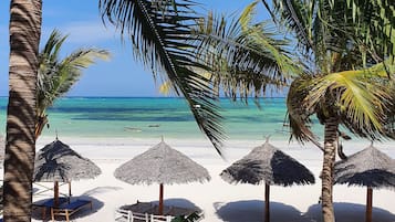 On the beach, sun-loungers, beach towels