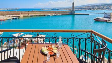 Enjoy a meal on the terrace with a view of the harbor and boats.