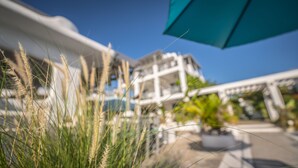 A building with a modern architectural style, featuring a prominent white facade and a blue awning. - La Casona Blanca Location Location  (Esperanza)