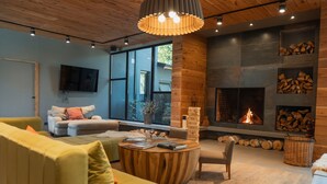 Una sala de estar moderna con un sofá amarillo, una mesa de centro de madera y una chimenea.