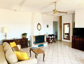 Relax in this stylish living room with a fireplace, sofa, and TV.
